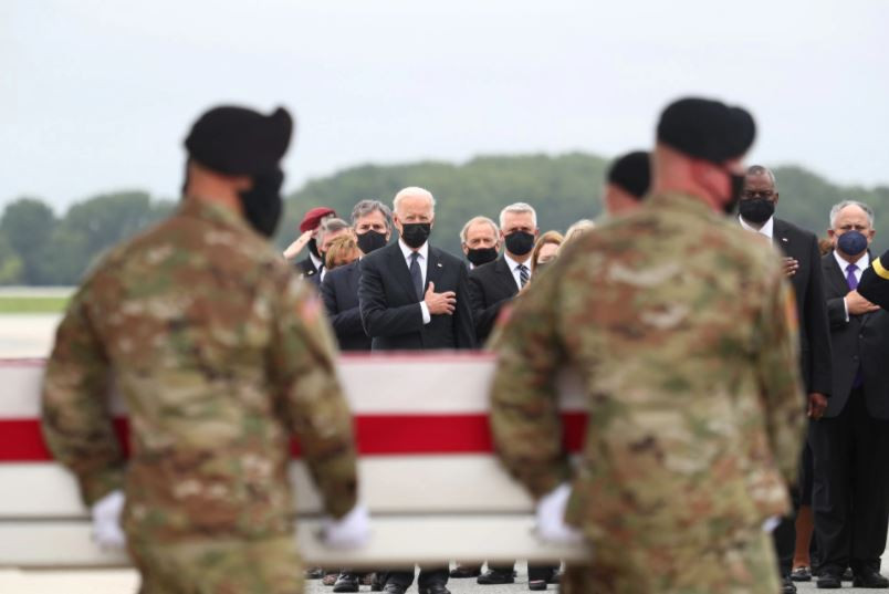 u s president joe biden salutes during the dignified transfer of the remains of u s military service members who were killed by a suicide bombing at the hamid karazi international airport at dover air force base in dover delaware us august 29 2021 photo reuters