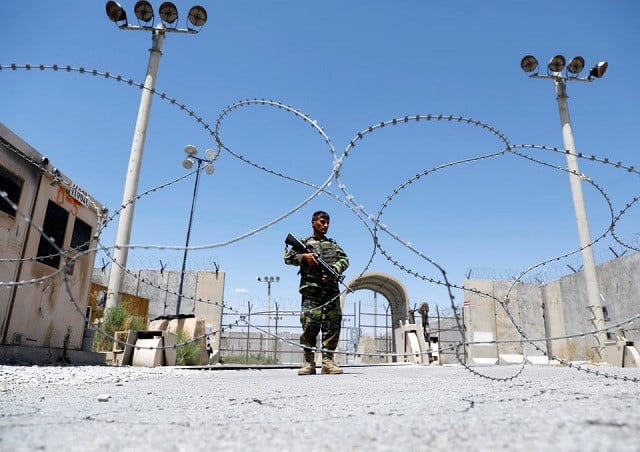 an afghan national army soldier stands guard at the gate of bagram us air base on the day the last of american troops vacated it parwan province afghanistan july 2 2021 photo reuters