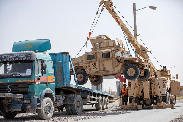 US Army soldiers and contractors load High Mobility Multi-purposed Wheeled Vehicles, HUMVs, to be sent for transport as US forces prepare for withdrawl, in Kandahar, Afghanistan, July 13, 2020. PHOTO: REUTERS