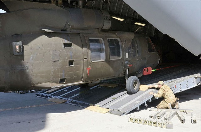 Aerial porters work with maintainers to load a UH-60L Blackhawk helicopter into a US Air Force C-17 Globemaster III during the withdrawl of American forces in Afghanistan, June 16, 2021. PHOTO: REUTERS