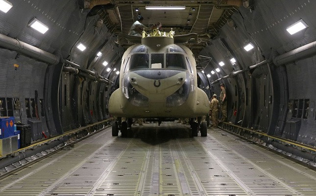 Aerial porters work with maintainers to load a CH-47 Chinook helicopter into a US Air Force C-17 Globemaster III during the withdrawl of American forces in Afghanistan, June 16, 2021. PHOTO: REUTERS