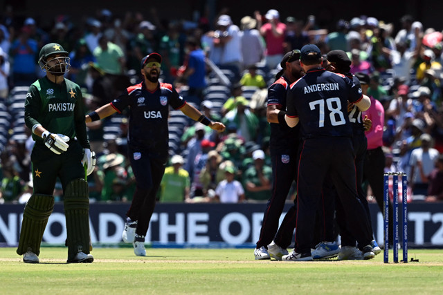 usa s players celebrate after winning the game as pakistan s shadab khan walks off at the grand prairie cricket stadium in grand prairie texas on june 6 2024 photo afp