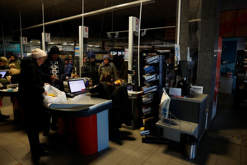 people shop in a supermarket as kharkiv suffers an electricity outage amid russia s attack on ukraine in kharkiv ukraine october 17 2022 photo reuters