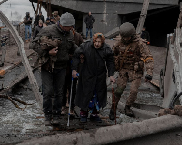 an elderly woman is helped while crossing a destroyed bridge as she tries to leave the city of irpin in the kyiv region ukraine march 5 2022 photo reuters an elderly woman is helped while crossing a destroyed bridge as she tries to leave the city of irpin in the kyiv region ukraine march 5 2022 photo reuters