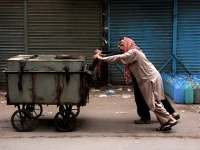 two men push a cart along as karachi faces water shortages photo reuters
