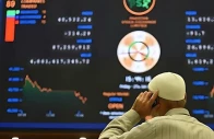 a broker talks on a phone as he watches latest share prices at the pakistan stock exchange in karachi on january 27 2023 afp