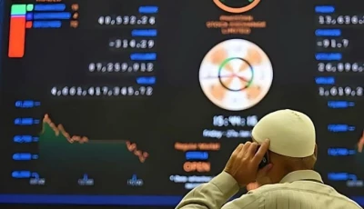 a broker talks on a phone as he watches latest share prices at the pakistan stock exchange in karachi on january 27 2023 afp