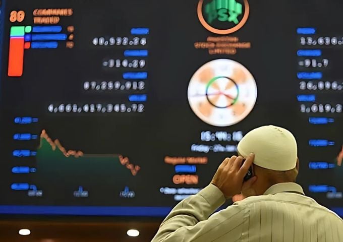 a broker talks on a phone as he watches latest share prices at the pakistan stock exchange in karachi on january 27 2023 afp