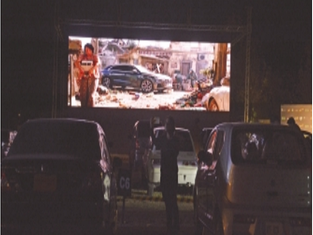 people watch a movie from their cars in islamabad s first drive in cinema photo express people watch a movie from their cars in islamabad s first drive in cinema photo express
