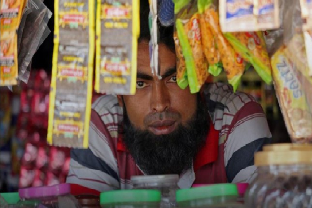 a man from the rohingya community looks on as he sits inside his shop at a camp on the outskirts of jammu october 5 2018 picture taken october 5 2018 reuters