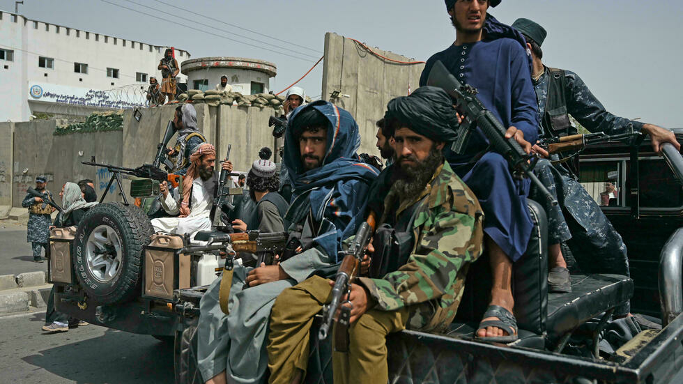 taliban fighters patrol outside the shaheed rabbani education university in kabul aamir qureshi afp