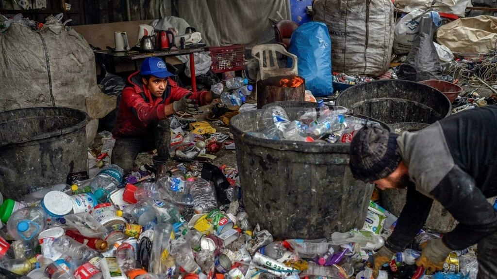 refugees dig up plastic bottles glass and other waste they then sort and sell in bulk afp