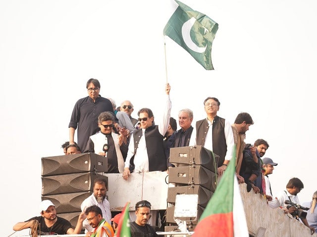 imran khan stands atop a container as pti begins its long march to the capital photo pti twitter