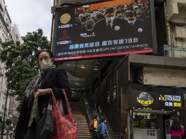 a woman wearing mask walks past an outdoor screen displaying a live broadcast of the memorial service for late former chinese president jiang zemin in hong kong tuesday dec 6 2022 a formal memorial service was held tuesday at the great hall of the people the seat of the ceremonial legislature in the center of beijing photo ap a woman wearing mask walks past an outdoor screen displaying a live broadcast of the memorial service for late former chinese president jiang zemin in hong kong tuesday dec 6 2022 a formal memorial service was held tuesday at the great hall of the people the seat of the ceremonial legislature in the center of beijing photo ap