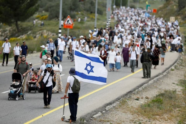 israeli settlers hold a protest march from tapuach junction to the israeli settler outpost of evyatar in the israeli occupied west bank april 10 2023 reuters israeli settlers hold a protest march from tapuach junction to the israeli settler outpost of evyatar in the israeli occupied west bank april 10 2023 reuters