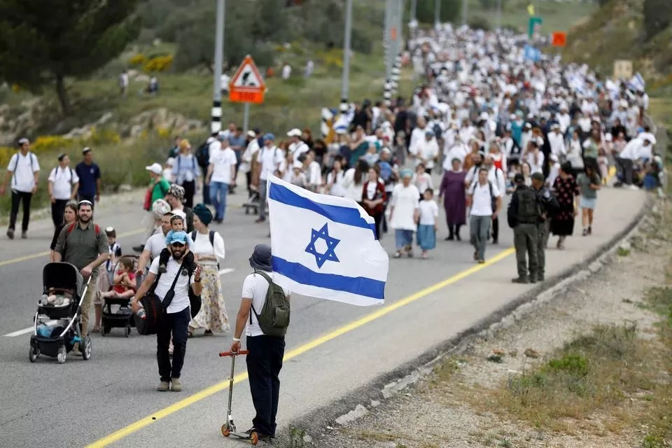 israeli settlers hold a protest march from tapuach junction to the israeli settler outpost of evyatar in the israeli occupied west bank april 10 2023 reuters israeli settlers hold a protest march from tapuach junction to the israeli settler outpost of evyatar in the israeli occupied west bank april 10 2023 reuters
