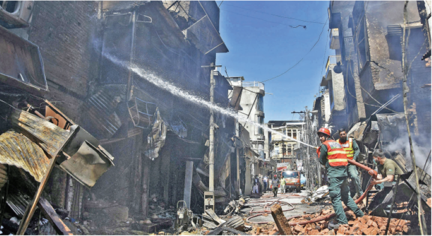 burnt to ashes the cooling process continues in the fire hit urdu bazaar as smoke rises from the shops gutted in the blaze