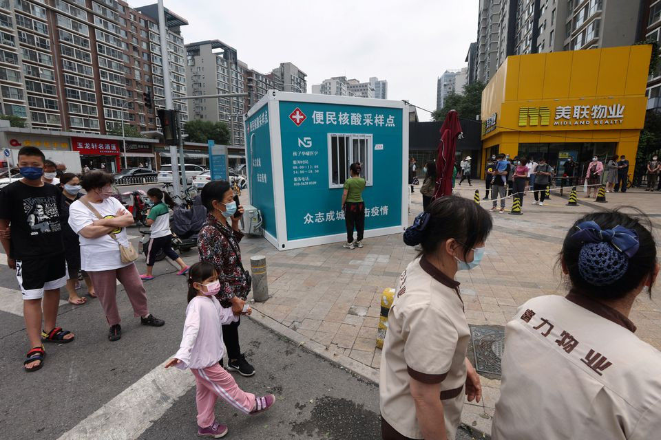 people line up for nucleic acid tests at a mobile testing booth following the coronavirus disease covid 19 outbreak in beijing china june 13 2022 reuters