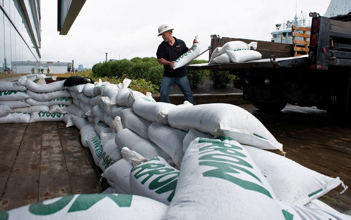 francis bruhm project manager for general contractor g r kelly places sandbags around the doors of the nova scotia power building before the arrival of hurricane fiona in halifax nova scotia canada september 23 2022 reuters ingrid bulmer file photo