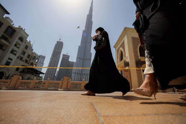 women walk past the burj khalifa in dubai united arab emirates june 11 2021 photo reuters file women walk past the burj khalifa in dubai united arab emirates june 11 2021 photo reuters file