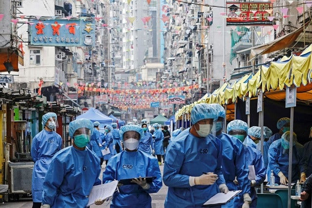 health workers are seen in protective gear inside a locked down portion of the jordan residential area to contain a new outbreak of the coronavirus disease covid 19 in hong kong china january 23 2021 reuters health workers are seen in protective gear inside a locked down portion of the jordan residential area to contain a new outbreak of the coronavirus disease covid 19 in hong kong china january 23 2021 reuters