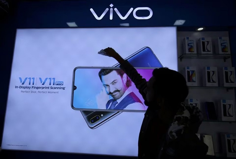 a man cleans a screen displaying a phone model of chinese smartphone maker vivo inside a shop in ahmedabad india december 14 2018 photo reuters