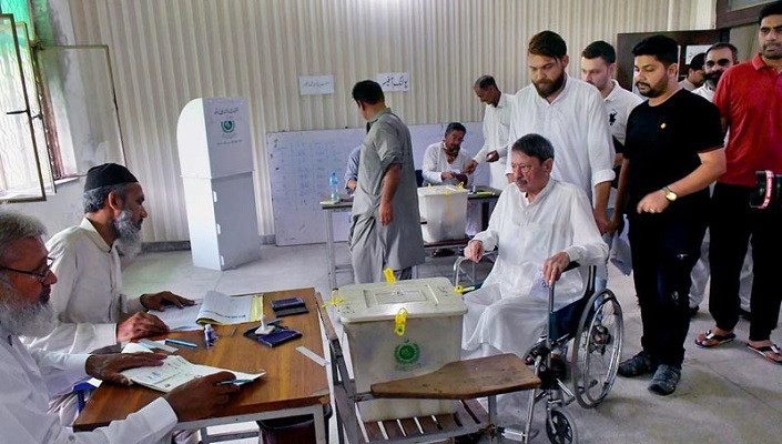 a senior citizen on a wheelchair arrives to cast their vote during by elections on july 17 2022 photo app