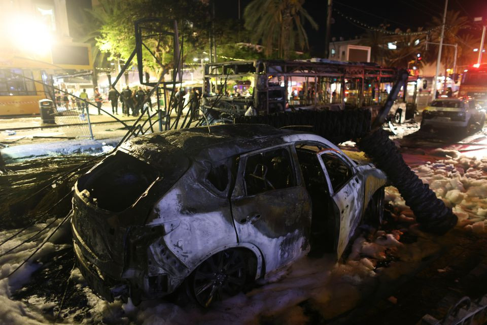 Burnt vehicles are seen at the scene where a rocket launched from the Gaza Strip hit, in Holon, Israel May 11, 2021. PHOTO: REUTERS