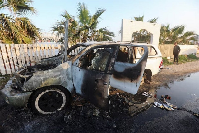 a person looks at a vehicle where employees from the wck were killed in an israeli airstrike in deir al balah in gaza april 2 photo reuters