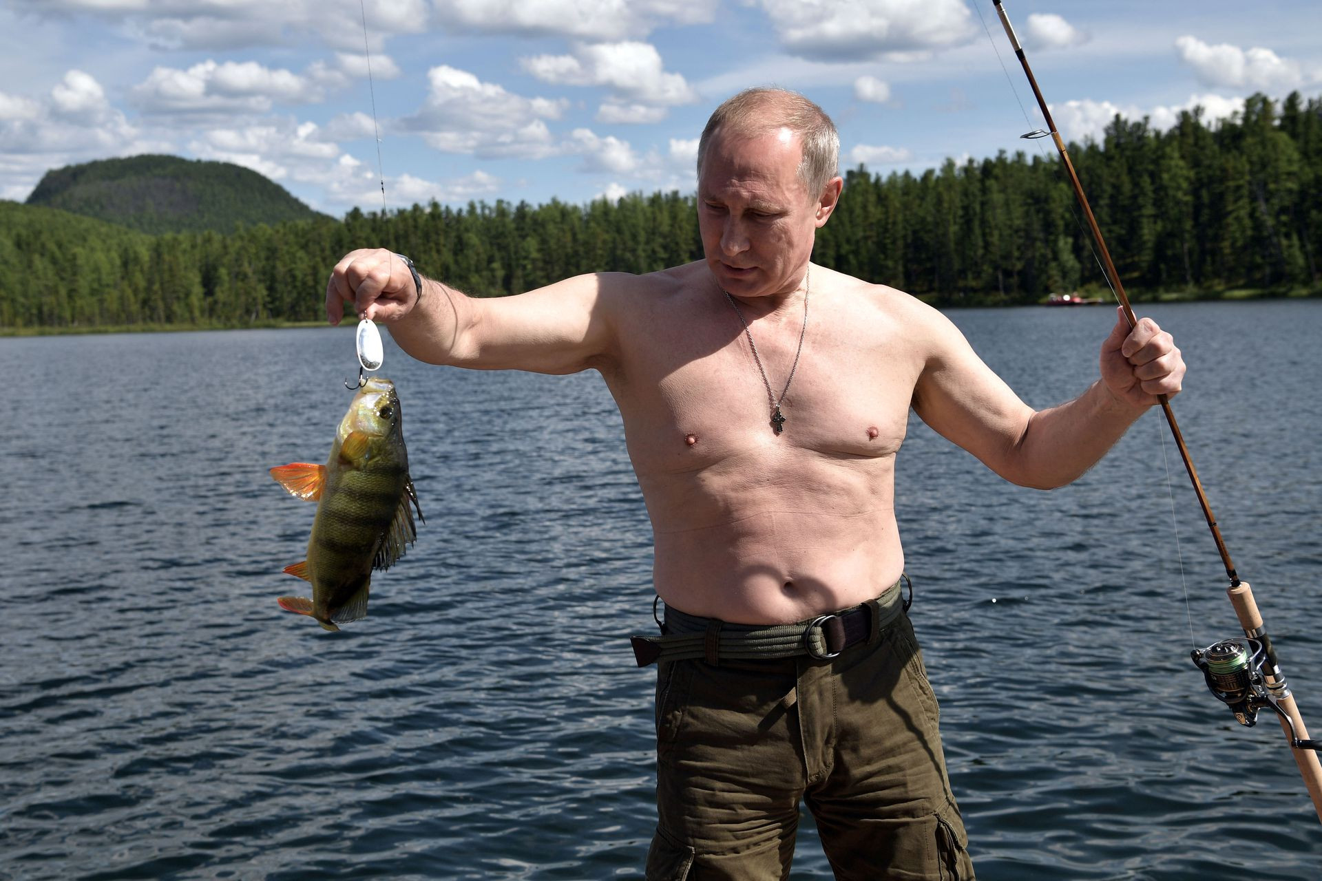 russian president vladimir putin holds a fish he caught during the hunting and fishing trip which took place on august 1 3 in the republic of tyva in southern siberia russia in this photo released by the kremlin on august 5 2017 photo reuters file