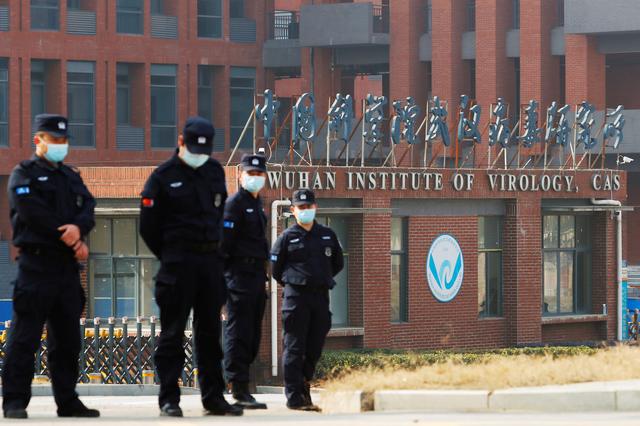 security personnel keep watch outside wuhan institute of virology during the visit by the world health organisation who team tasked with investigating the origins of the coronavirus disease covid 19 in wuhan hubei province china february 3 2021 photo reuters