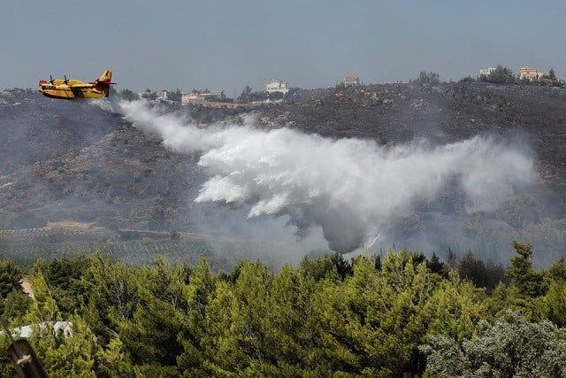 a canadair aircraft makes a water drop as a wildfire burns in the pikermi suburb of athens greece july 20 2022 photo reuters