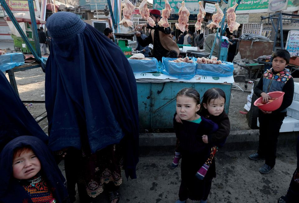 a mother shops with her children at the market in kabul afghanistan october 29 2021 reuters