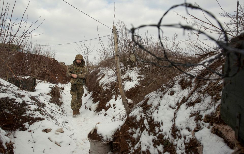 a service member of the ukrainian armed forces walks at combat positions near the line of separation from russian backed rebels near horlivka in the donetsk region ukraine january 22 2022 picture taken january 22 2022 photo reuters