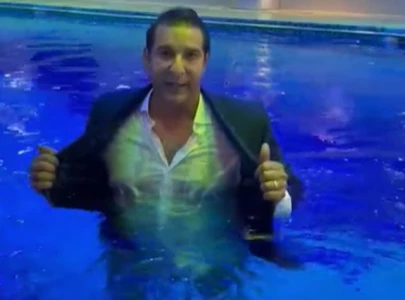 watch wasim akram hits back at trolls by wearing suit in swimming pool