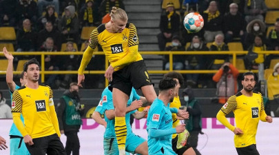 haaland brace sees dortmund trim bayern s lead