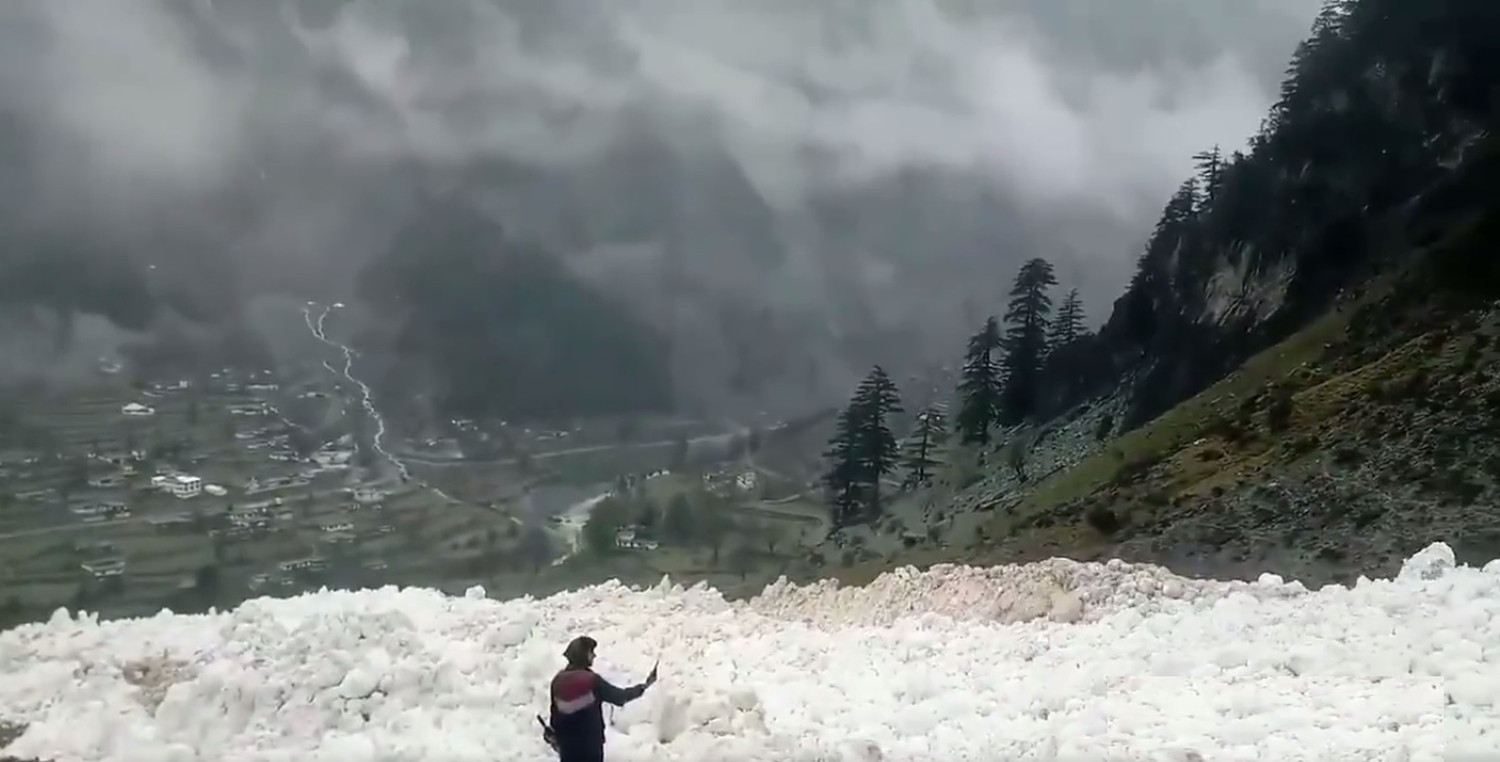 glacier melt a man takes picture from his mobile phone of staggering quantity of snow in kalam on sunday photo twitter pak weather