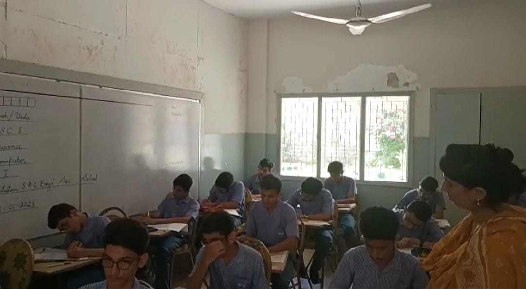 children give matric papers amid power supply cuts in karachi photo express