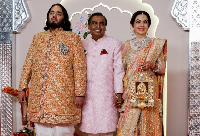 groom anant ambani poses for pictures with nita ambani and mukesh ambani on the red carpet on the day of his wedding with radhika merchant in mumbai india july 12 2024 photo reuters groom anant ambani poses for pictures with nita ambani and mukesh ambani on the red carpet on the day of his wedding with radhika merchant in mumbai india july 12 2024 photo reuters