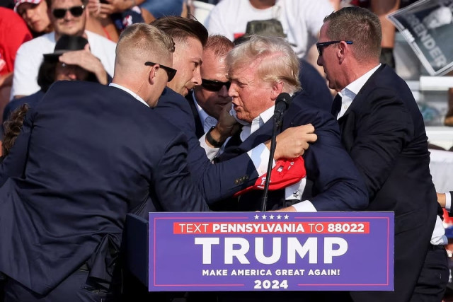 the secret service assists republican presidential candidate and former president donald trump during a campaign rally at the butler farm show in butler pennsylvania july 13 2024 photo reuters the secret service assists republican presidential candidate and former president donald trump during a campaign rally at the butler farm show in butler pennsylvania july 13 2024 photo reuters