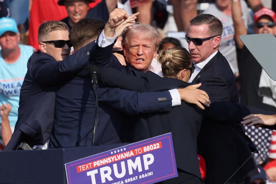 republican presidential candidate and former us president donald trump is assisted by security personnel after gunfire rang out during a campaign rally at the butler farm show in butler pennsylvania us july 13 2024 photo reuters