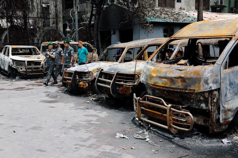 security personnel walk past damaged vehicles that were set afire by a mob during clashes after violence erupted following protests by students against government job quotas in dhaka bangladesh on july 22 2024 photo reuters