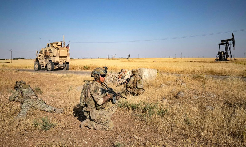 us troops patrol near an oil field in north eastern syria last year photo afp