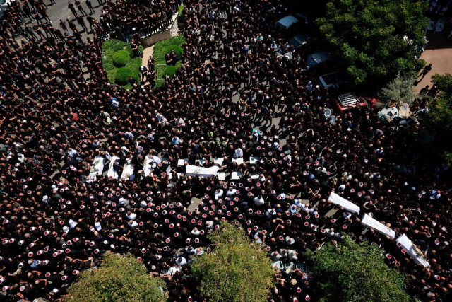 mourners carry coffins during the funeral of children who were killed at a soccer pitch by a rocket fired from lebanon in majdal shams a druze village in the israeli occupied golan heights on july 28 2024 photo reuters mourners carry coffins during the funeral of children who were killed at a soccer pitch by a rocket fired from lebanon in majdal shams a druze village in the israeli occupied golan heights on july 28 2024 photo reuters