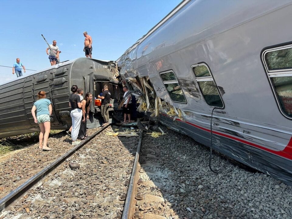 people are seen near the derailed carriages of a passenger train after a collision with a truck in the volgograd region in russia on july 29 2024 photo reuters