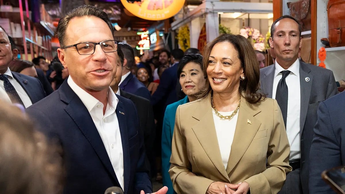 vice president kamala harris and pennsylvania governor josh shapiro speak to the press while making a stop at the reading terminal market in philadelphia pennsylvania on july 13 2024 photo afp