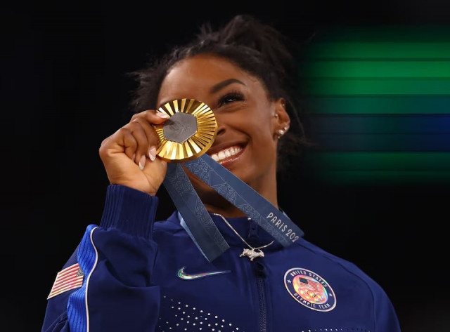 paris olympics 2024 artistic gymnastics gold medallist simone biles of united states celebrates on the podium at the bercy arena in paris france on august 01 2024 photo reuters paris olympics 2024 artistic gymnastics gold medallist simone biles of united states celebrates on the podium at the bercy arena in paris france on august 01 2024 photo reuters