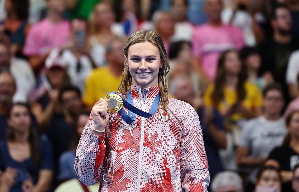 paris 2024 olympics   swimming   women s 200m butterfly gold medallist summer mcintosh of canada celebrates on the podium after winning at the paris la defense arena in nanterre france on august 01 2024 photo reuters