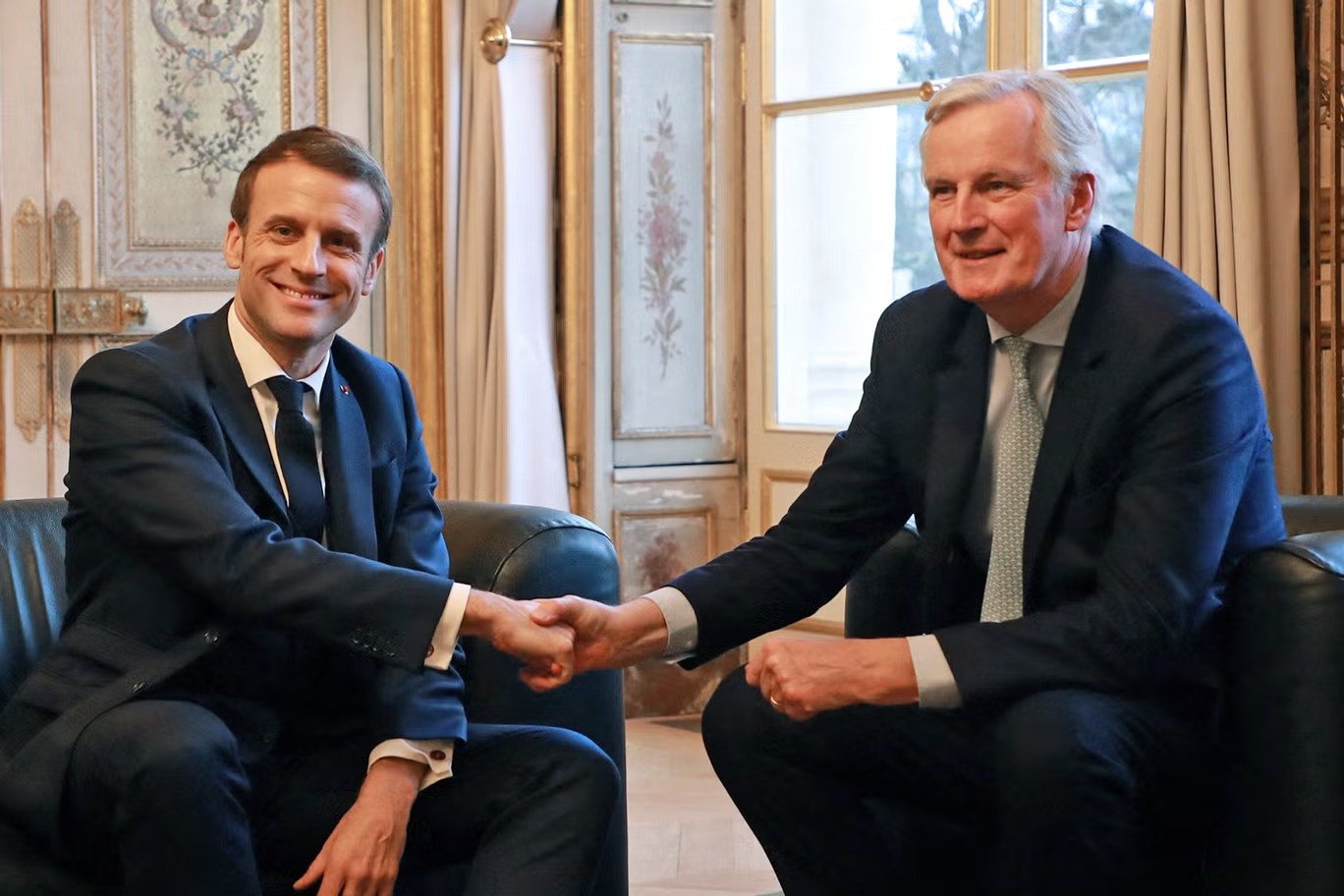 french president emmanuel macron poses with former eu brexit negotiator michel barnier photo afp