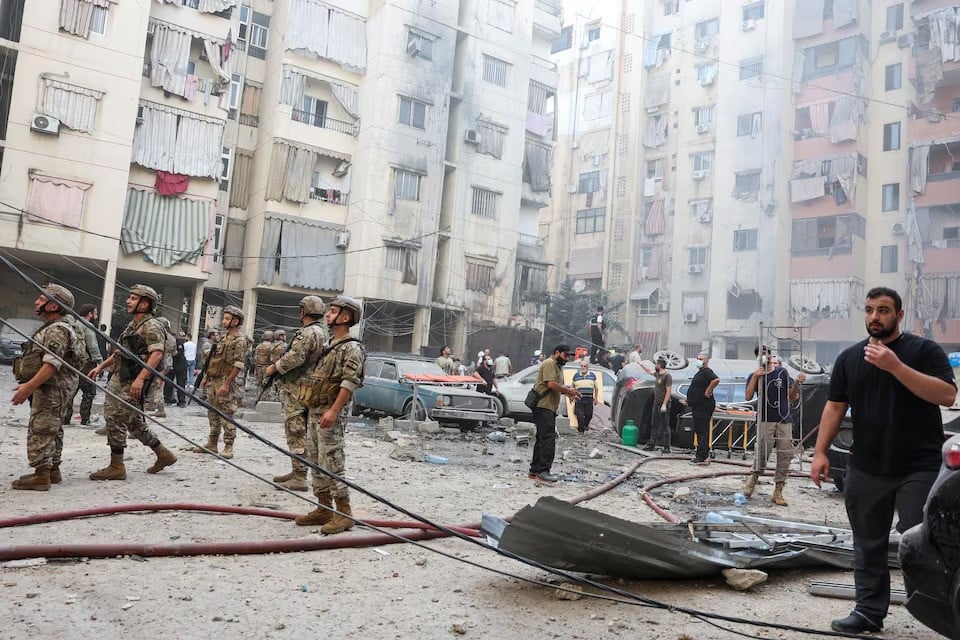 people and members of the military inspect the site of an israeli strike in the southern suburbs of beirut lebanon on september 20 2024 photo reuters